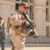 Man in military gear carrying a gun
