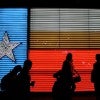 People in front of neon Texas flag