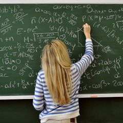 Girl doing math on chalkboard