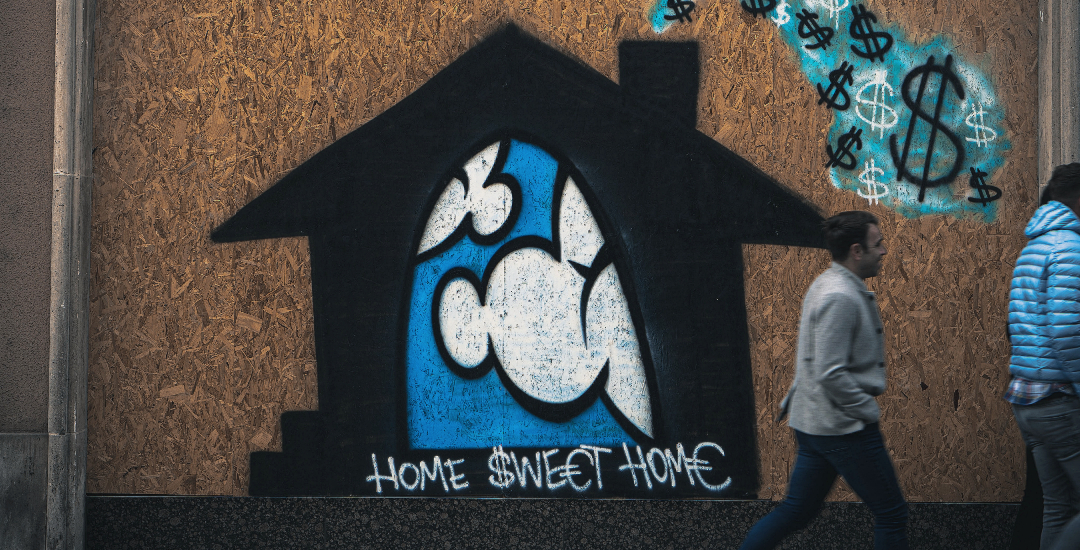Man walking by graffiti that says Home Sweet Home