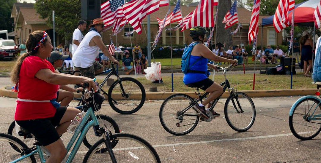 Families on bikes at a July Fourth parade in Houston's Northside neighborhood. Jimmy Castillo, CC BY-ND
