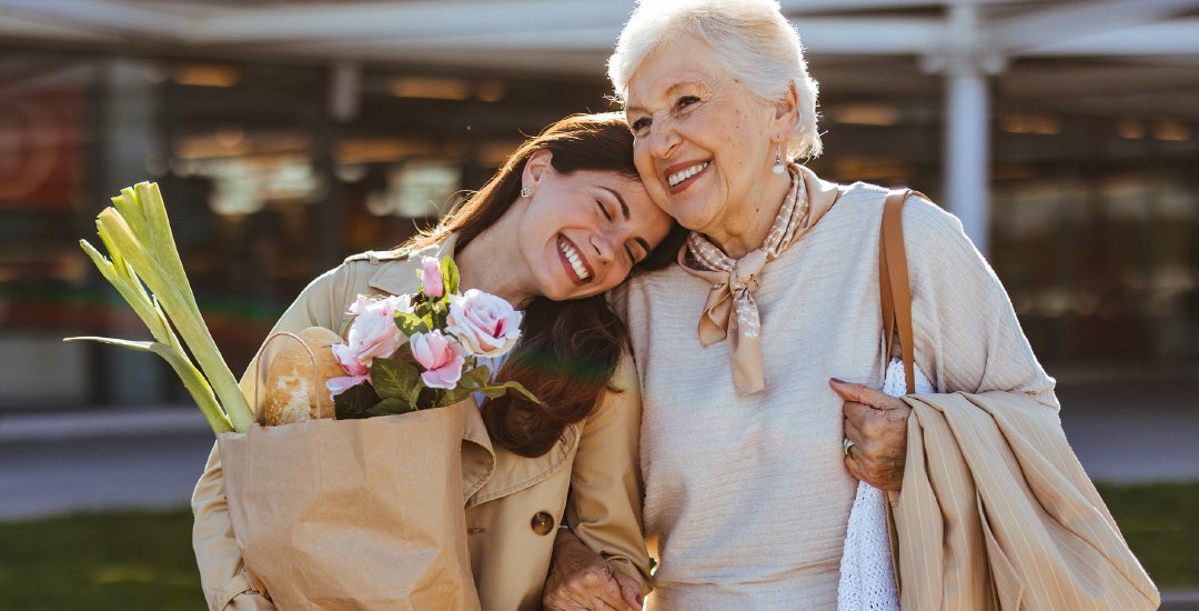 A young woman and older woman walking companionably