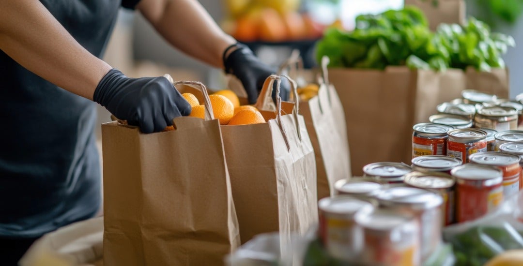 A food pantry worker collects and distributes groceries.