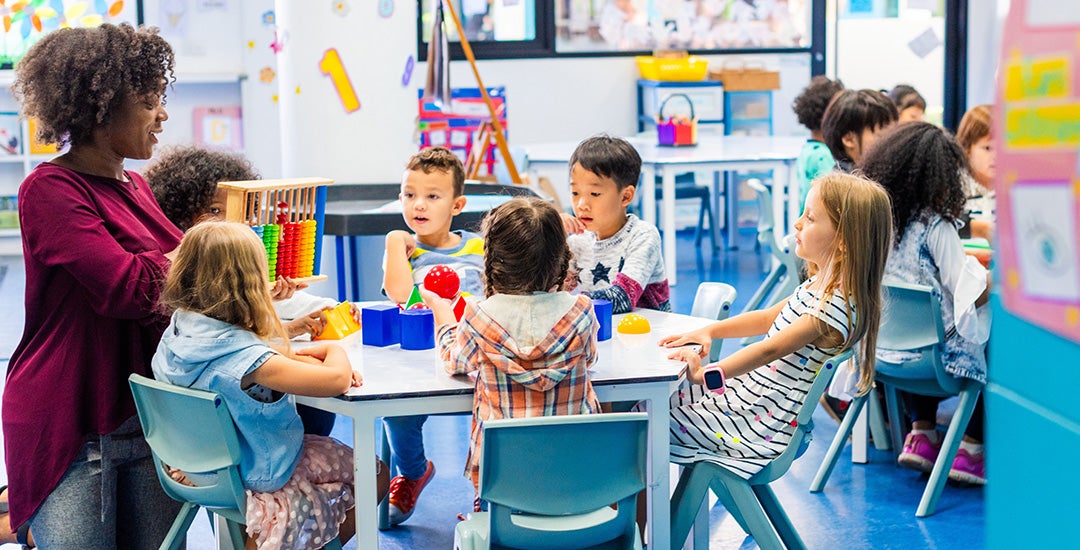 Pre-K classroom with teacher and students