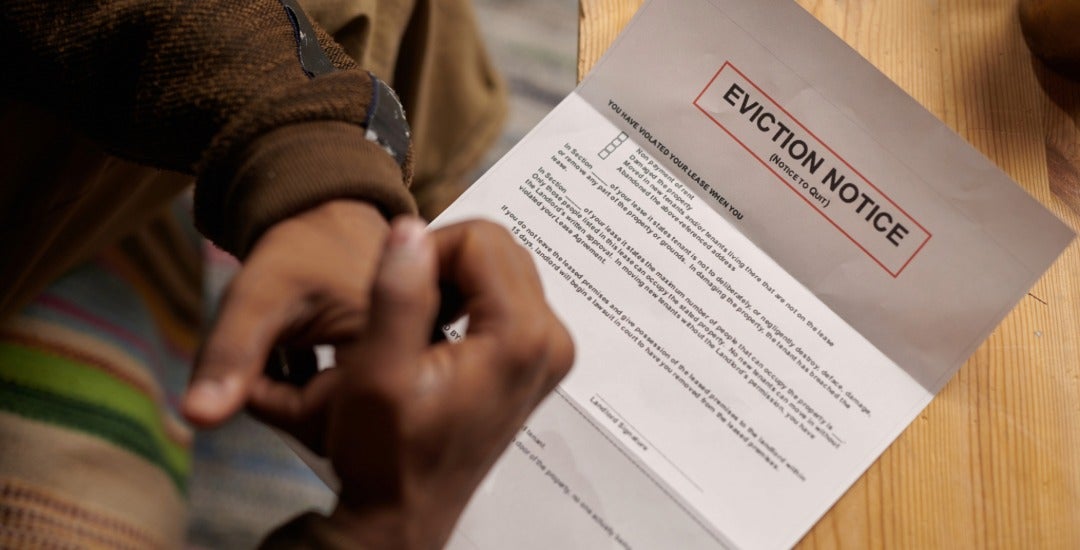 A tenant looks at an eviction notice.