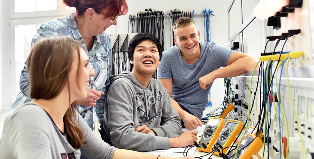 group of young students in vocational education and training for electronics 