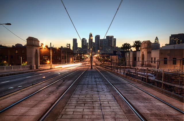 Empty railroad tracks with a skyline in the background
