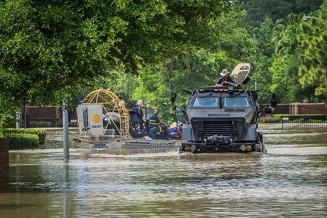 Photo of a truck moving through high flood waters