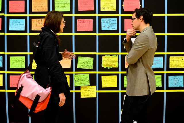 Professional people speaking over post-it notes