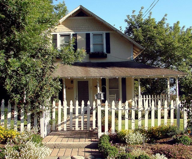 Home with a white picket fence in the front yard