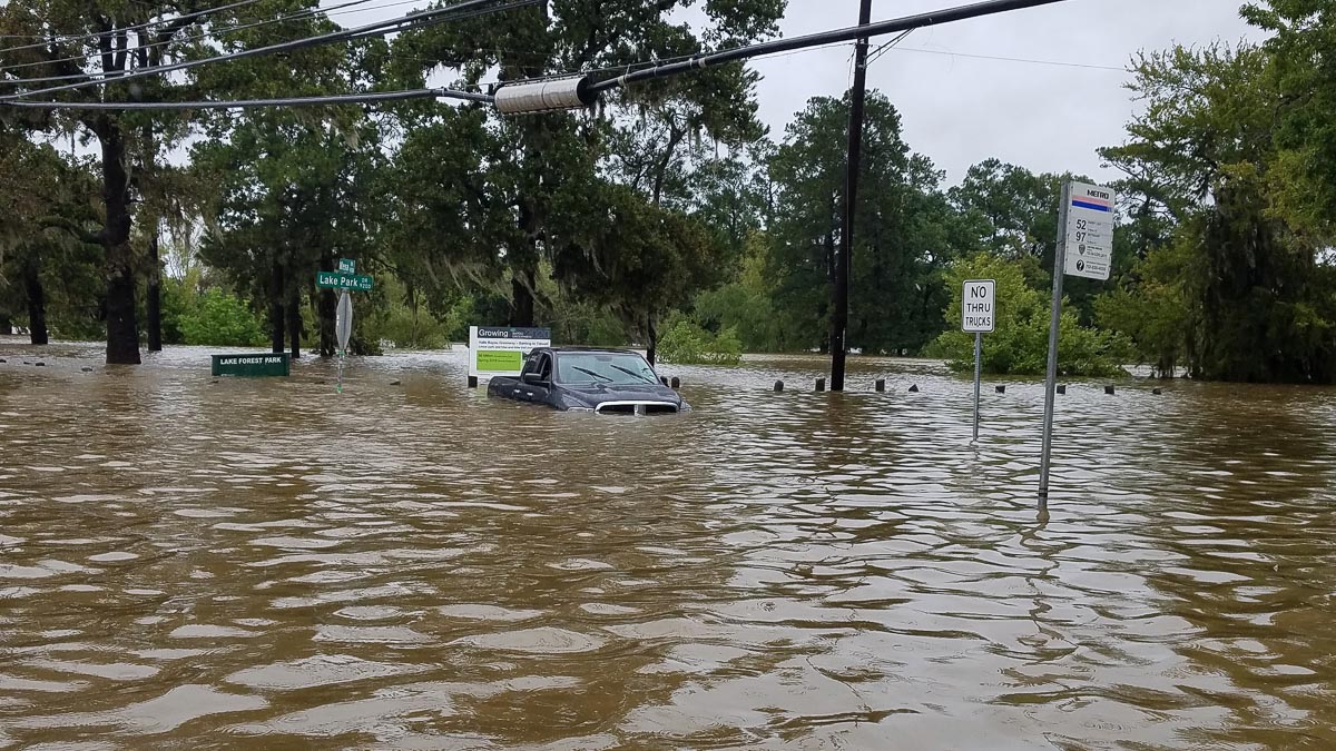 Street sign nearly submerged by flood water