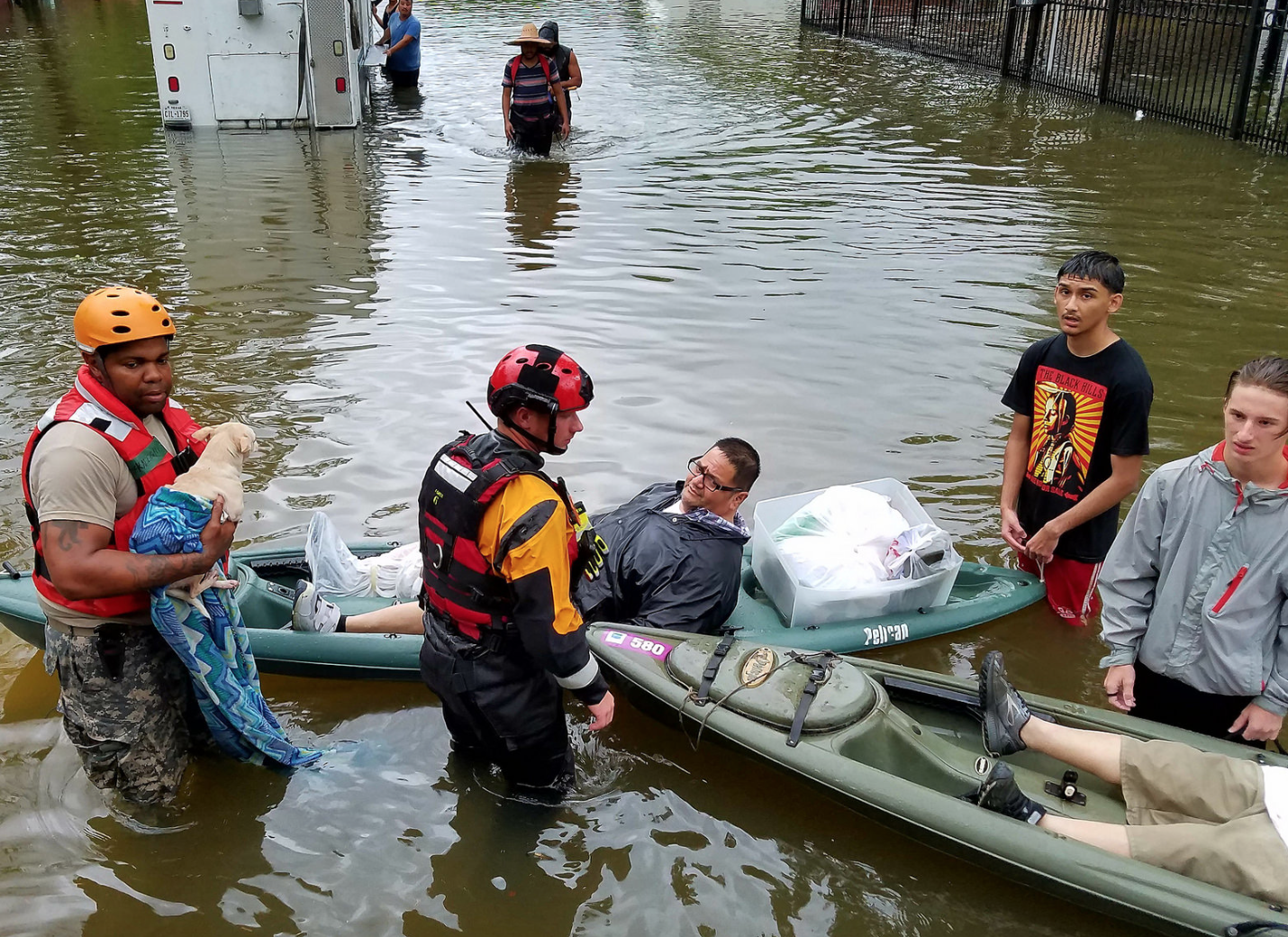 Men rescuing man during flood