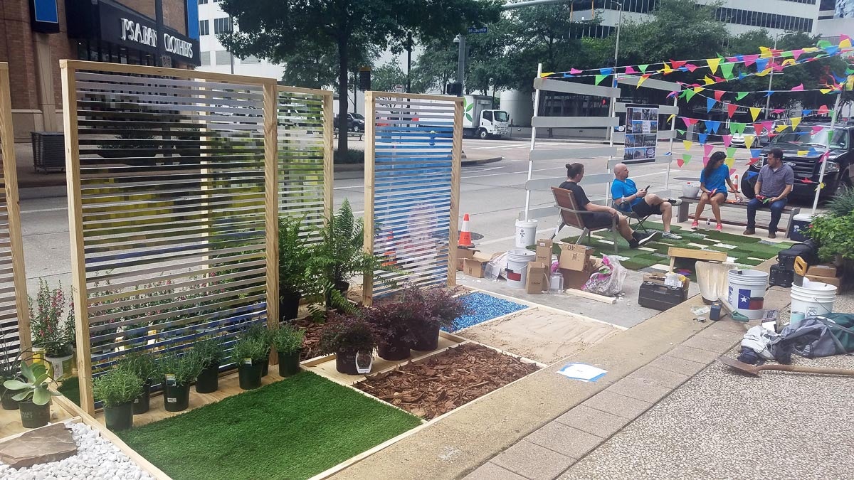 Participants interact with the Parking Day booths