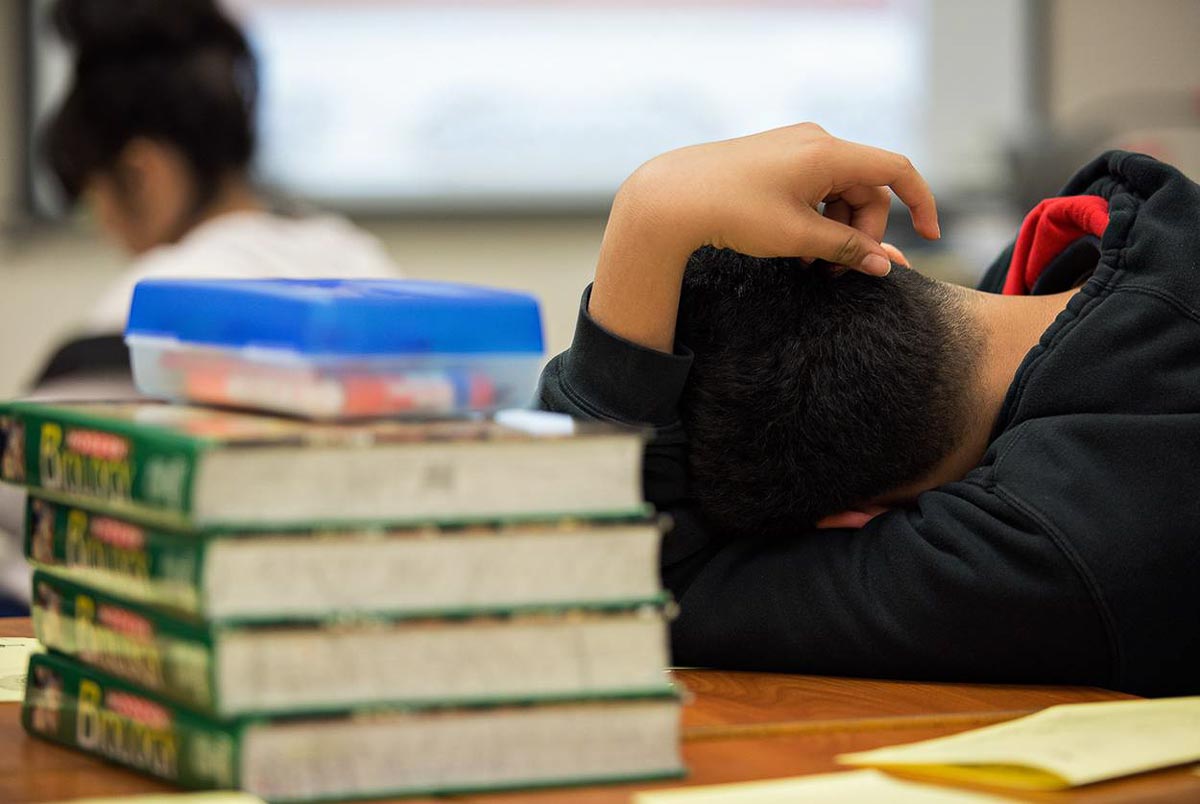 A student at the Elsik Ninth Grade Center rests during a lesson while participating in an after-school program.  Pu Ying Huang for The Texas Tribune