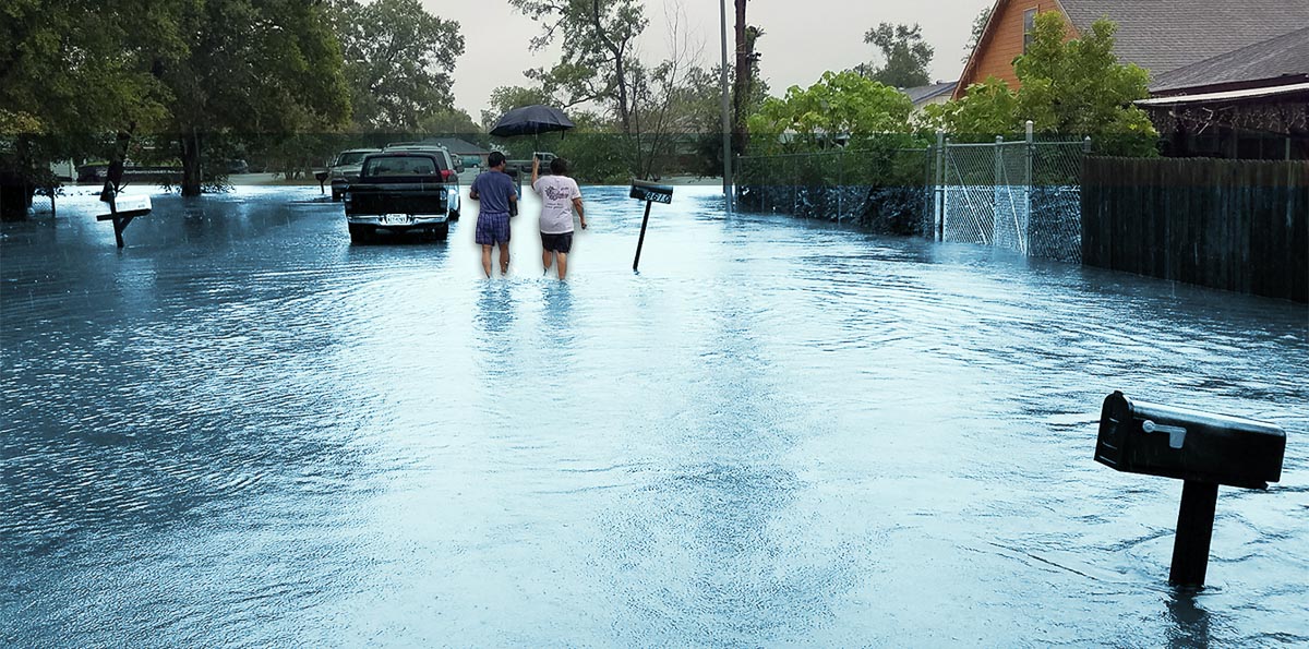 man and woman walk down a flooded street in Northeast Houston after Hurricane Harvey