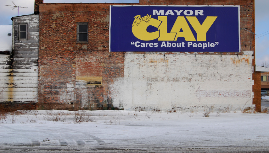 Image of election sign on brick wall for Mayor Clay in Indiana