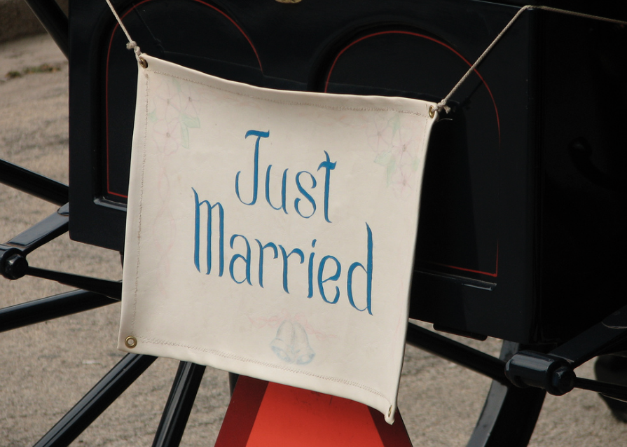 Just married sign hanging off the back of a carriage