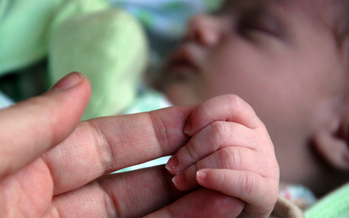 Infant holding hand