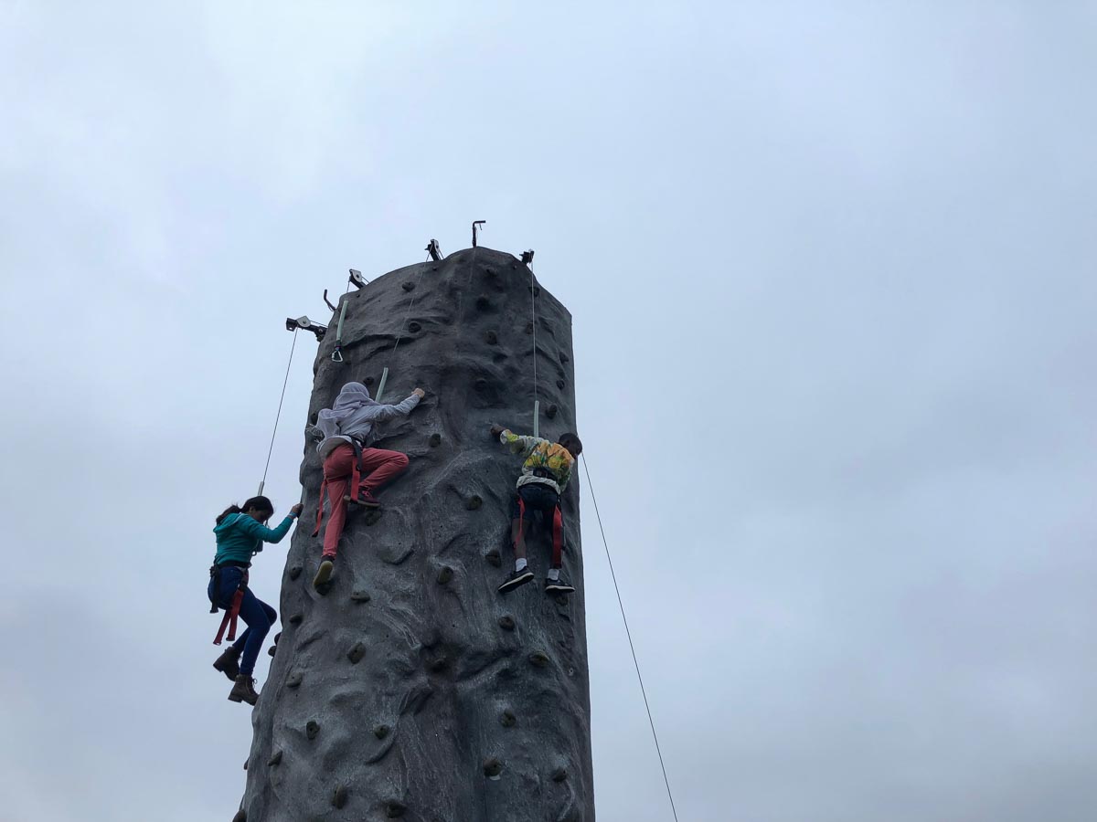Kids climb a rock wall at the fall festival