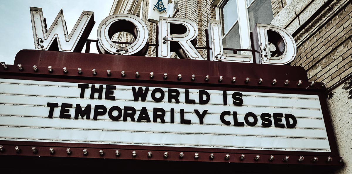 theater marquee reading the world is temporarily closed