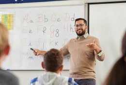 teacher in classroom teaching ABC 