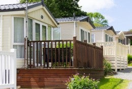 A neighborhood of manufactured homes along a street. 