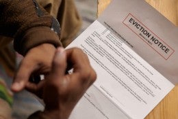 A tenant looks at an eviction notice. 