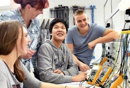 group of young students in vocational education and training for electronics 