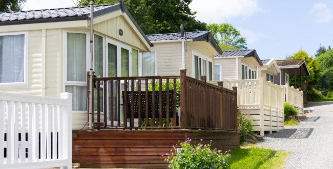 A neighborhood of manufactured homes along a street.