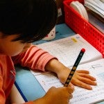 A child writes in a classroom