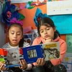 Two students reading together