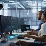Employees work in a data center to implement AI predictive maintenance systems.