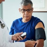 Patient gets his blood pressure tested at a doctor's office
