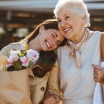 A young woman and older woman walking companionably
