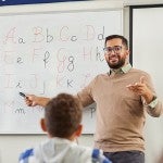 teacher in classroom teaching ABC