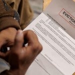 A tenant looks at an eviction notice.