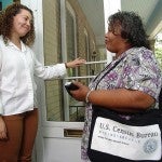 Census workers speaking to people at their doorway