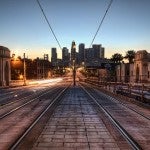 Empty railroad tracks with a skyline in the background