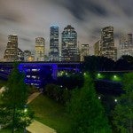 Blue Bayou lights at night with Houston skyline in the background