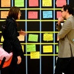 Professional people speaking over post-it notes