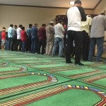 Men praying in the Mosque