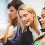 Woman teaching woman on the computer