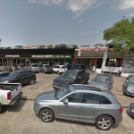 Parked cars lining the streets outside of Houston's Rice Village shopping area.