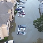 Flooded apartment building and cars
