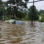 Street sign nearly submerged by flood water