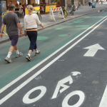 People walking beside a bike path
