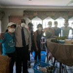 Group of people cleaning a flooded home