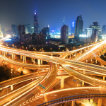 Highway at night with city skyline in the background