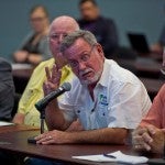 Man speaking to a group of other men