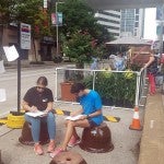 Participants interact with the Parking Day booths